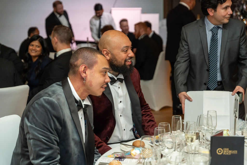 Guests seated together at a candlelit table at the Cyber Security Awards ceremony