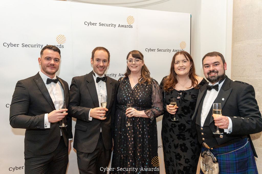 Winners in black tie gathered in front of the Cyber Security Awards backdrop at the ceremony